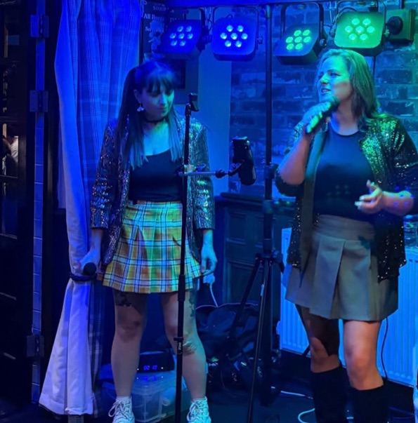 VHS performing under blue stage lights